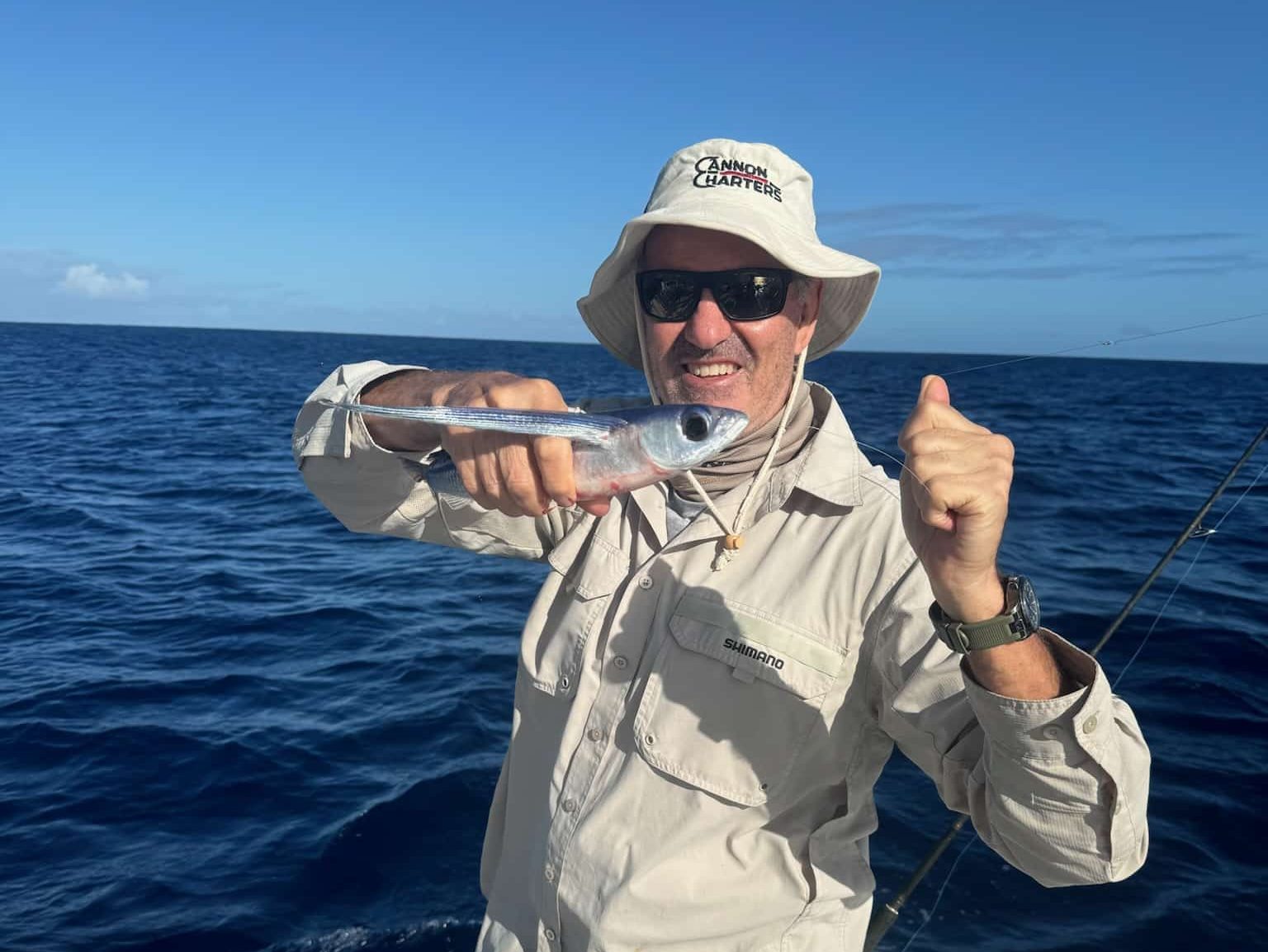 A Flying Fish being held by a fisho on the Ocean Blue Boat