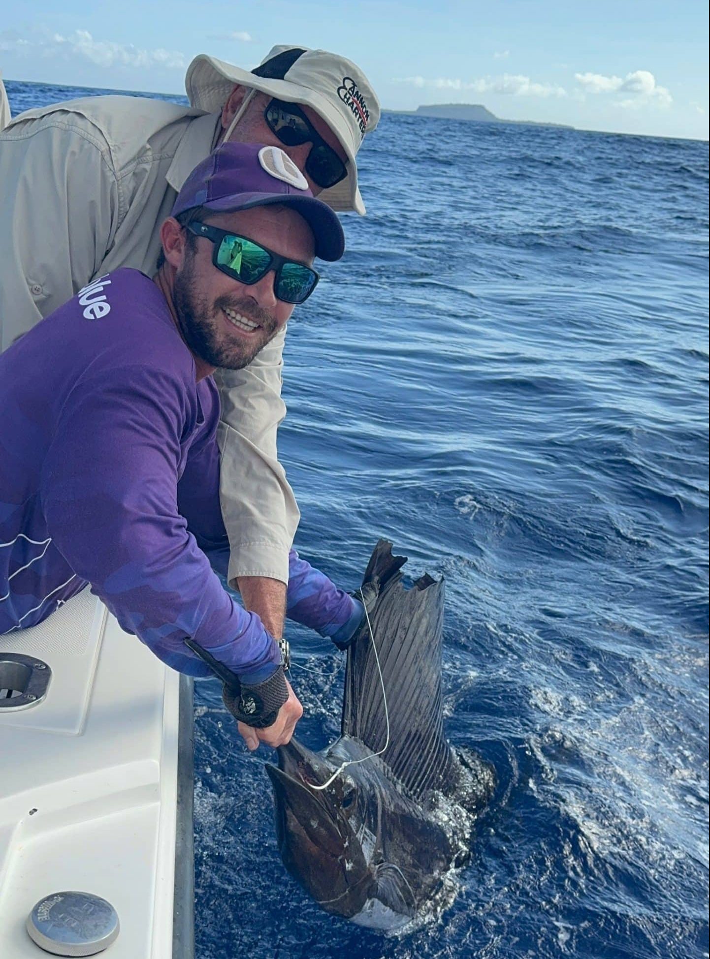 Sailfish being held alongside the Ocean Blue Boat