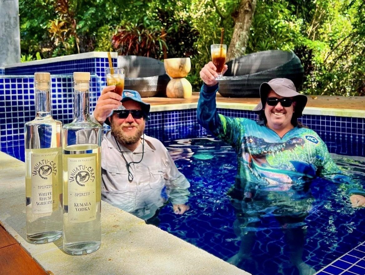 Mates Enjoying A Drink In Pool